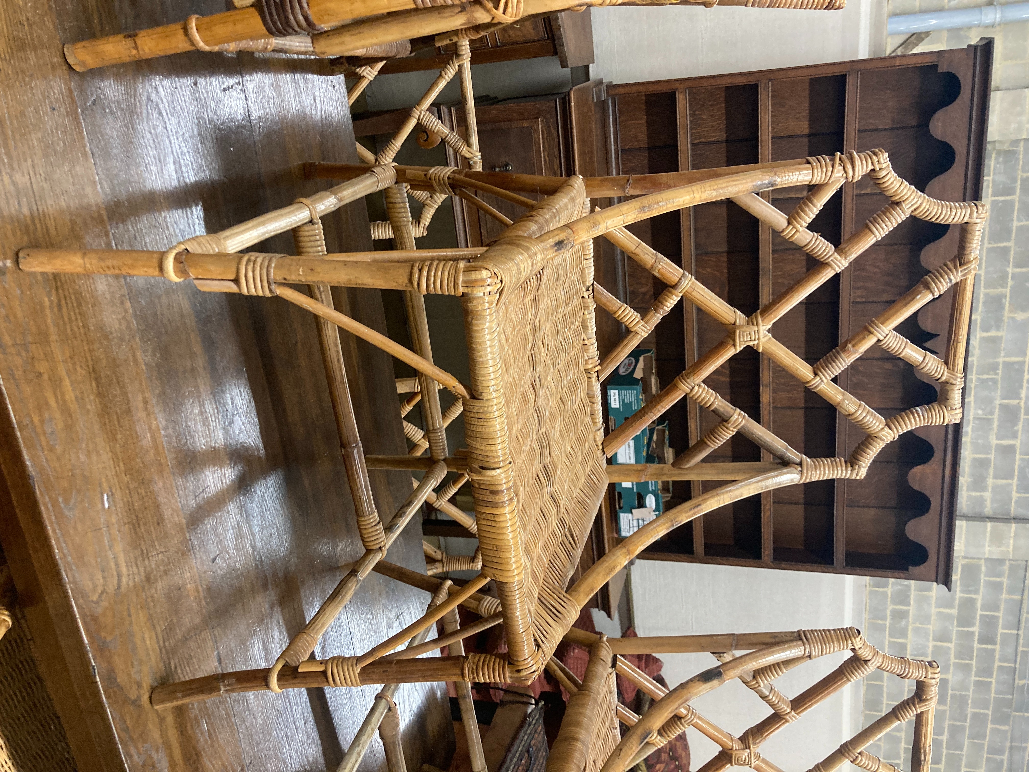 A set of nine caned bamboo chairs, five with arms